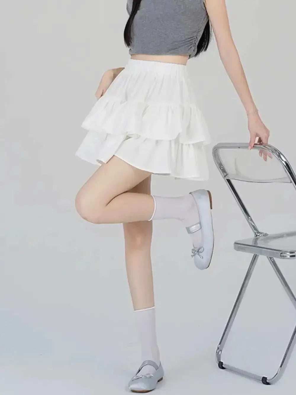 White tiered mini A-line skirt with high waist and ruffle details