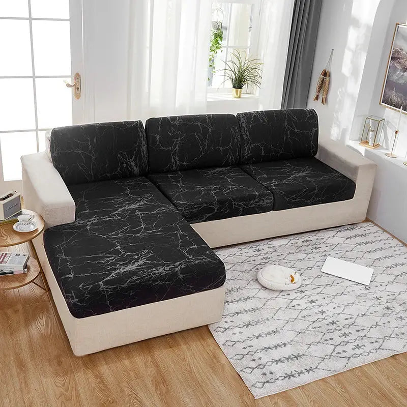 Elastic sofa cushion covers in black marble pattern on beige sectional; washable and removable