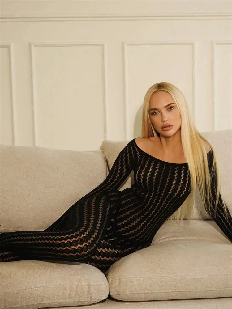 Simples Market Tossy black see-through jumpsuit with sheer mesh pattern worn by model on beige sofa