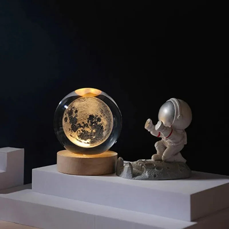 3D crystal ball night light on a wooden base with laser-engraved solar system globe; astronaut figurine beside.
