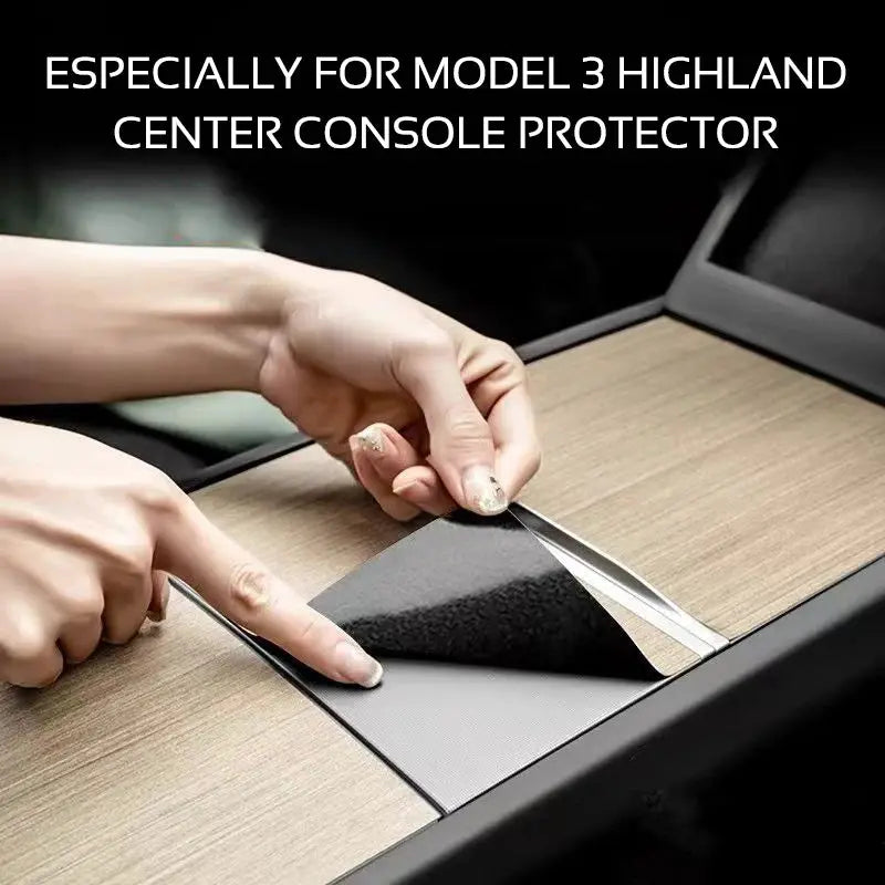 Center console protector film for Tesla Model 3 Highland Y Juniper; peel-and-stick woodgrain cover being applied.