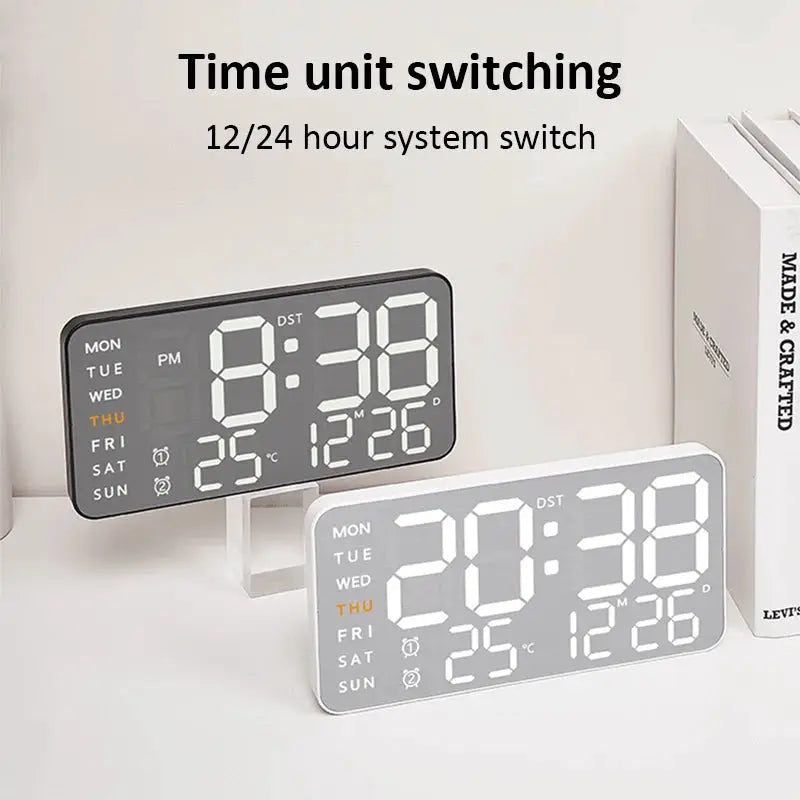 Two digital clocks with mirror-brushed finish in black and white, featuring large LED time display, date and temperature readouts