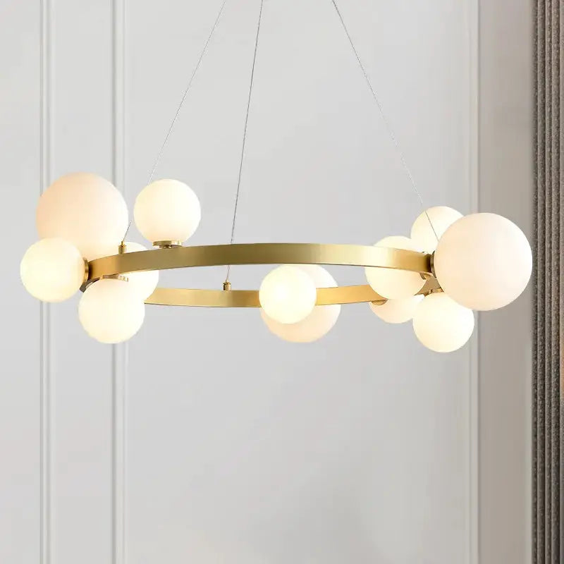 Gold-toned chandelier with two brass rings and frosted glass globe bulbs, hanging ceiling lamp for living room