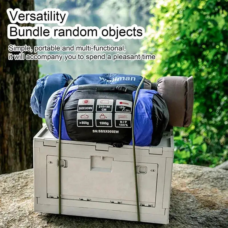 Outdoor heavy-duty bungee cords with carabiner hooks securing camping gear on a cooler