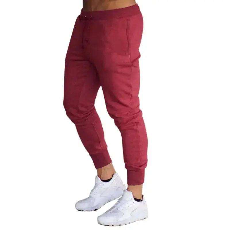 Men's maroon sports joggers with drawstring waist, tapered cuffs and side pockets