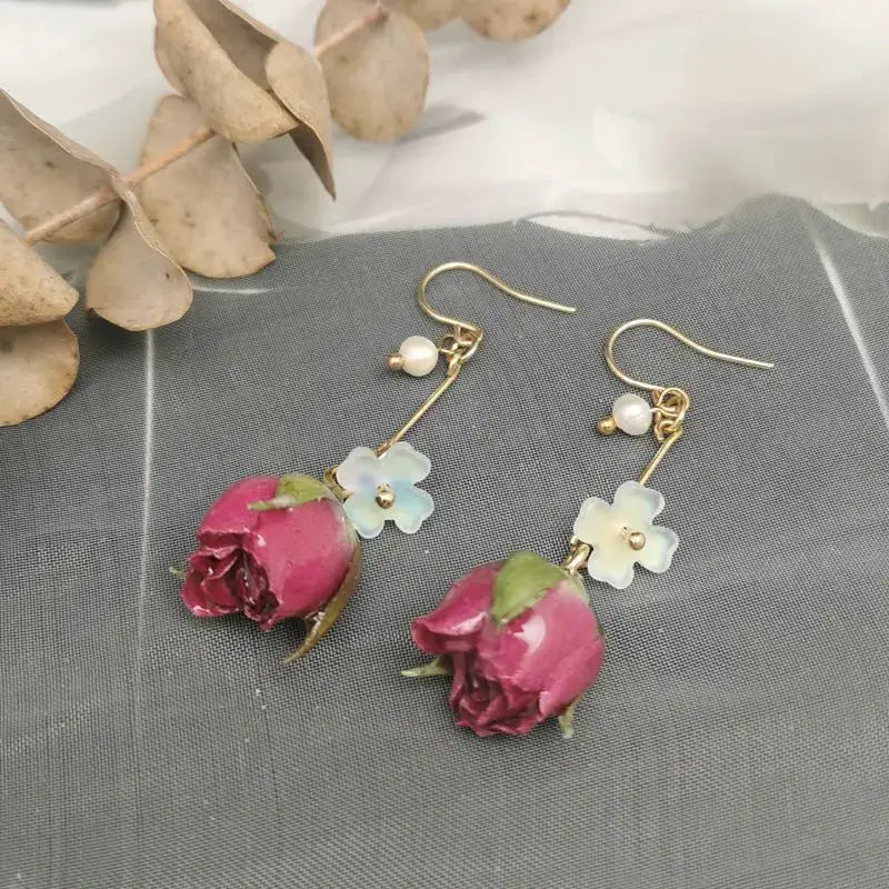 Red rose drop earrings by Simples Market with epoxy resin rose petals and a small flower charm, gold hooks (pair)