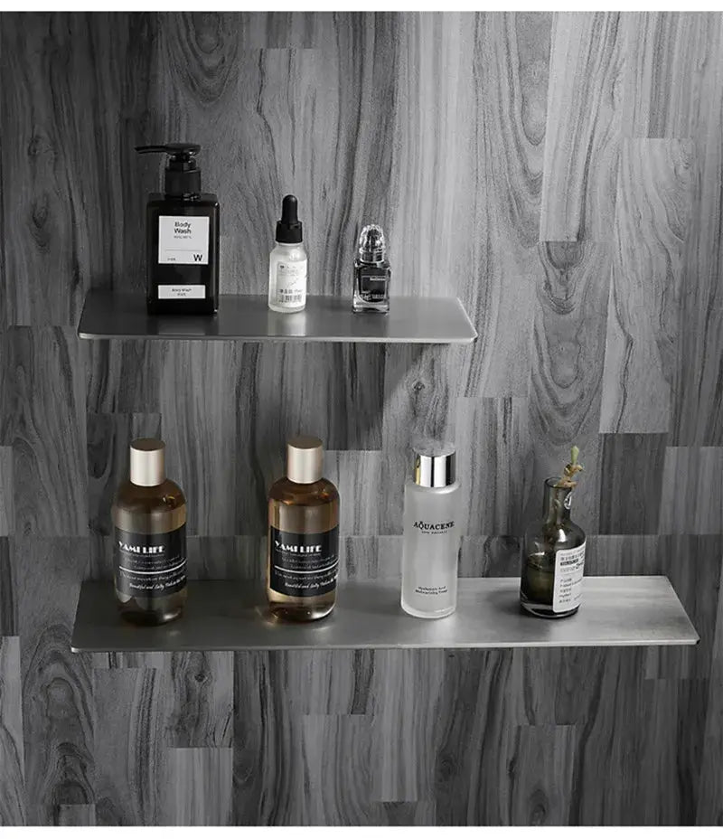 Brushed chrome stainless steel two-tier bathroom corner shelf with seven bottles and containers