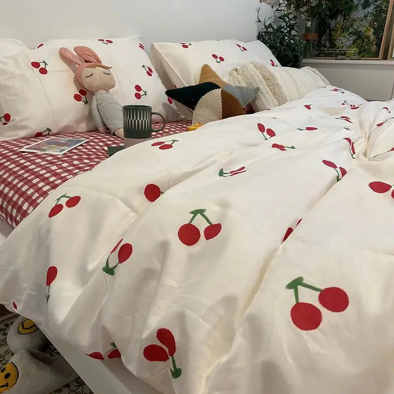 Pink floral bedding set with cherry print on white, includes duvet cover and pillowcases
