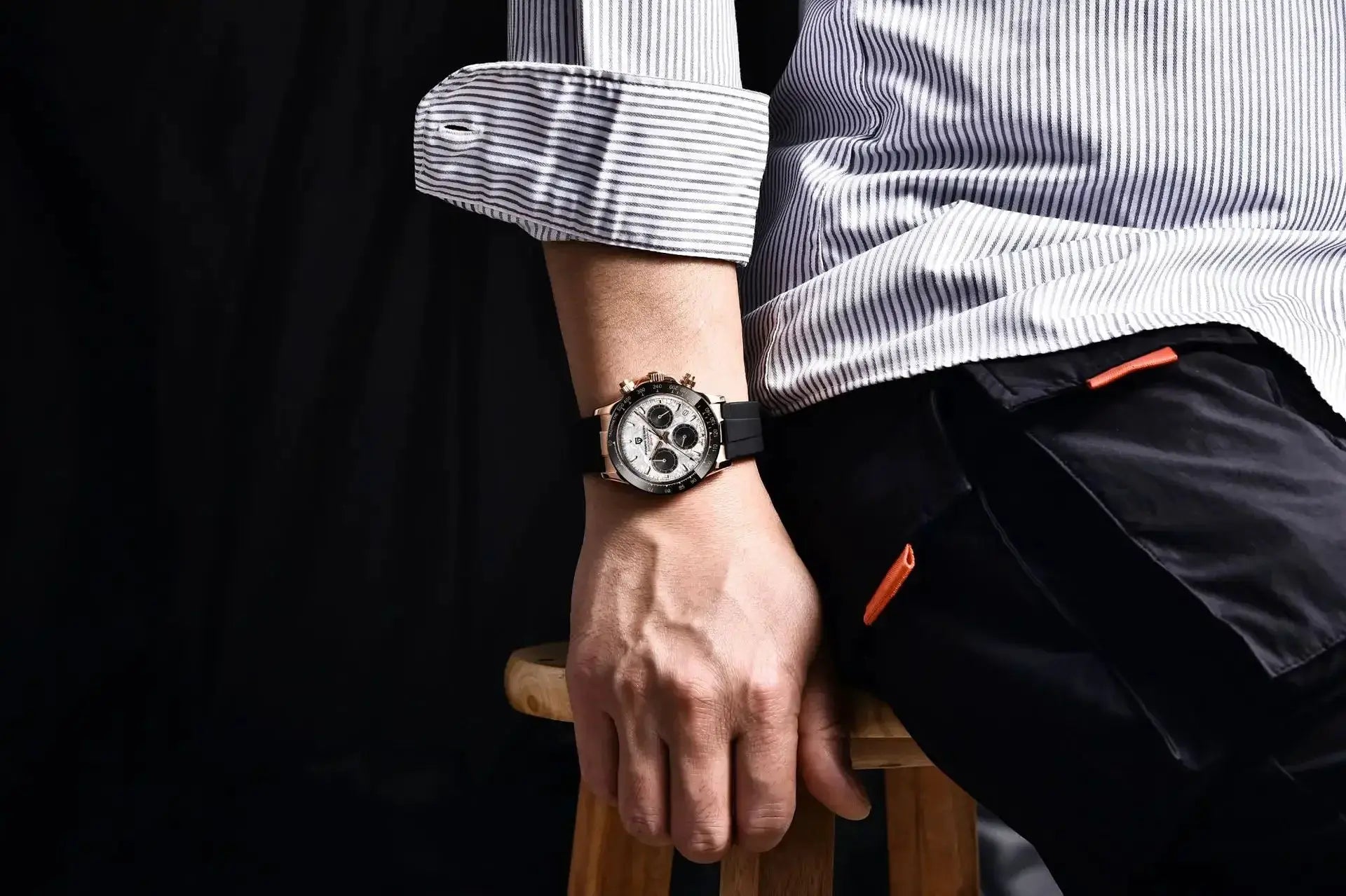 PAGANI DESIGN 40mm V2 watch on a man’s wrist with a black strap, rose-gold-tone case, white chronograph dial.