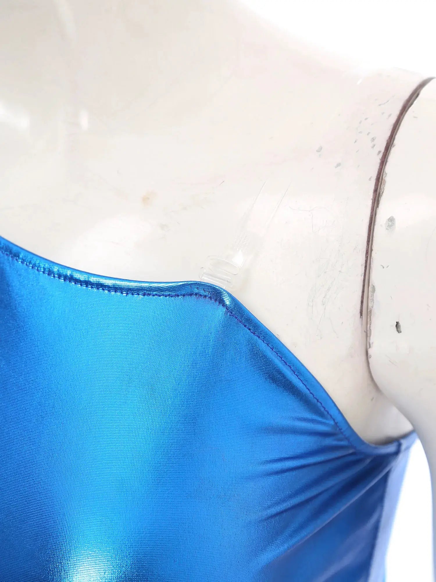 Womens blue metallic satin jumpsuit fabric close-up with seam detail