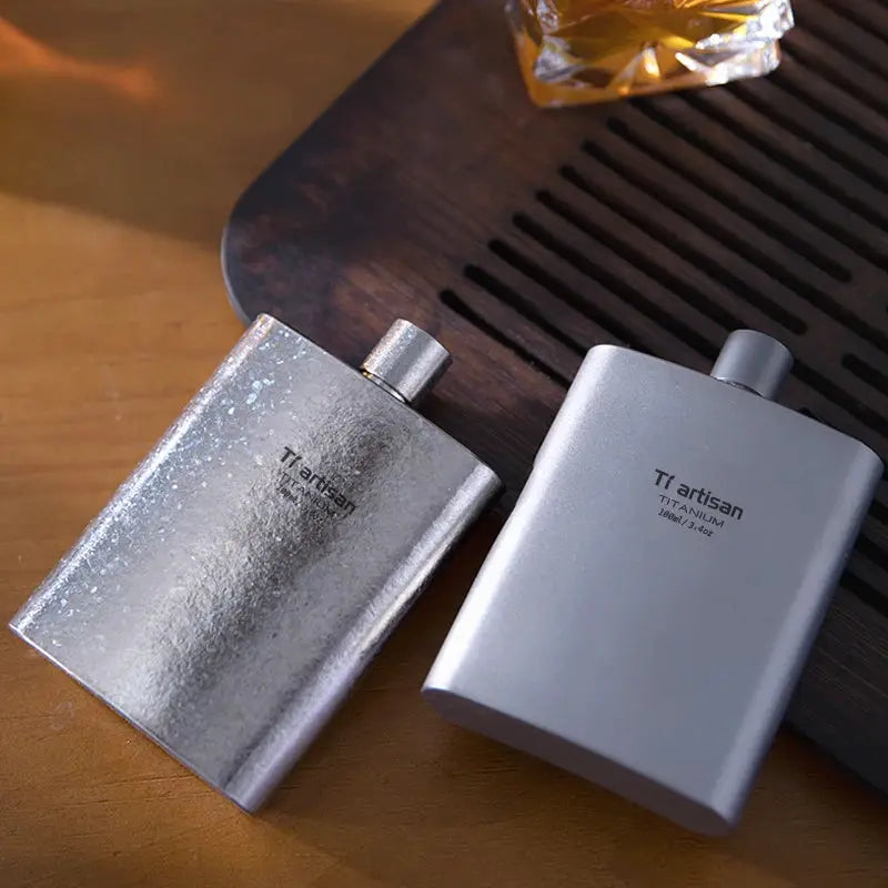 Tiartisan titanium hip flasks, two metal flasks in silver and matte gray.