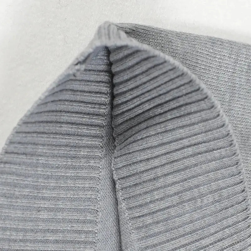 Men's sleeveless thick knit sweater vest with V-neck, ribbed grey fabric.