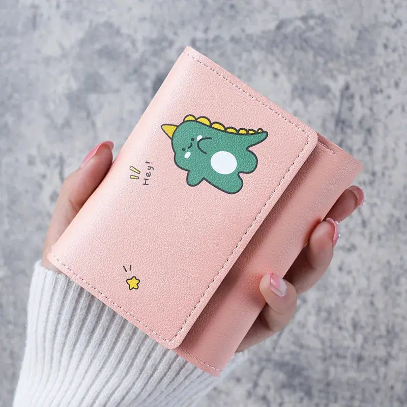 Wallet by Simples Market in pink with cartoon dinosaur design, compact coin purse and card holder