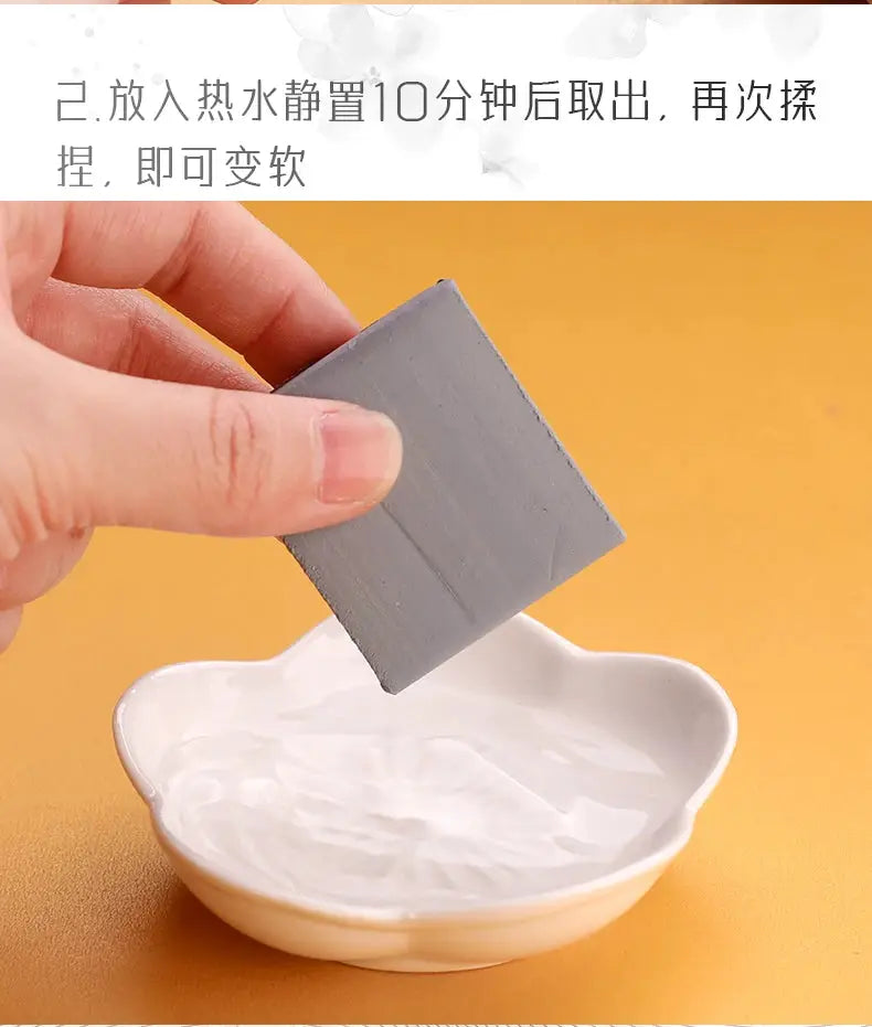 Kneaded eraser, gray, for drawing and lightening charcoal and pastel artwork, held in hand