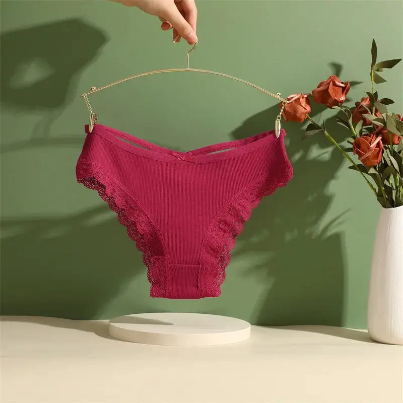 Women's pink cotton lace-trim briefs on a hanger; solid color with scalloped lace edges