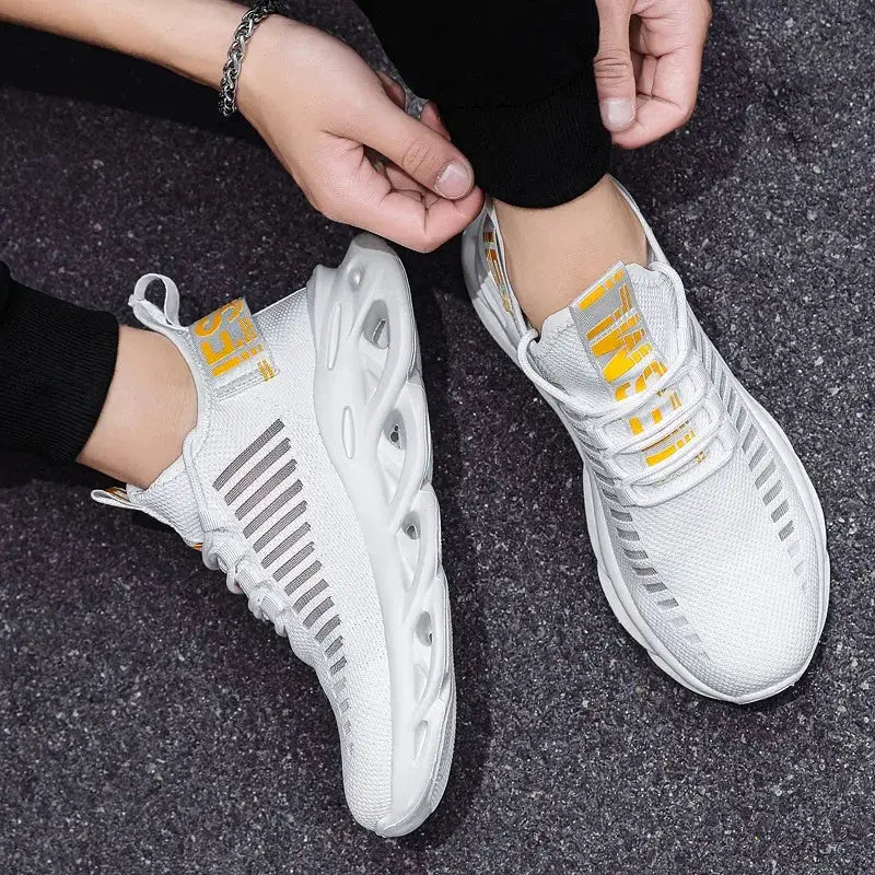 Pair of white unisex breathable walking sneakers with yellow laces and gray side stripes