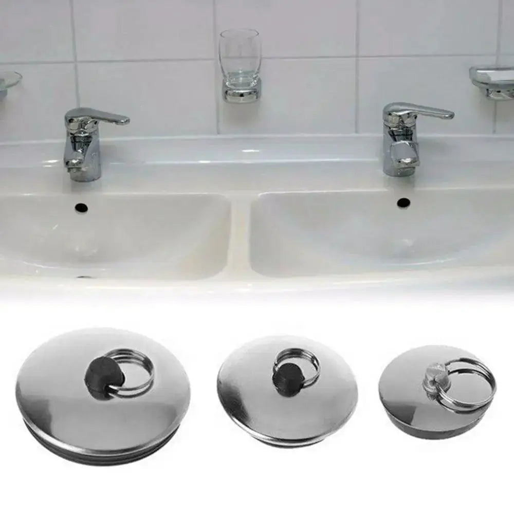 Three stainless steel bath drain stoppers with rubber seals.