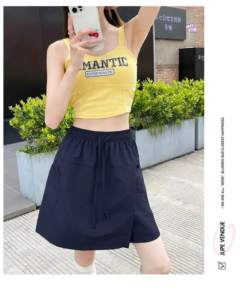 Two-piece women's shorts-skirt set: yellow crop top with navy high-waisted A-line shorts with pockets