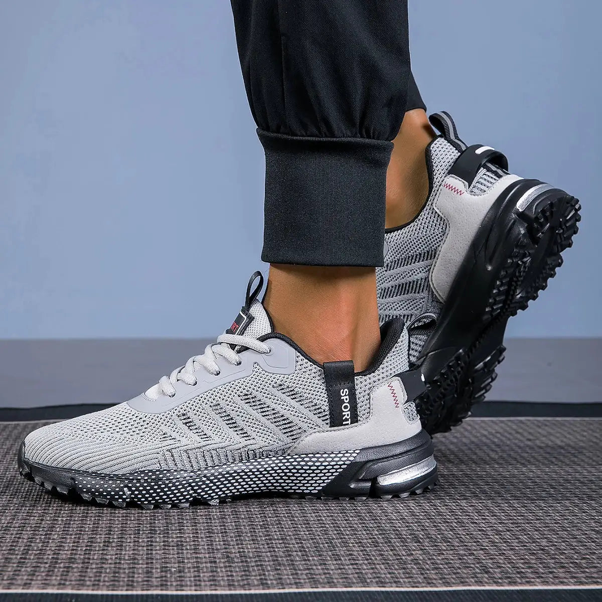 Men's running shoes in light gray mesh with black outsole; lightweight, breathable, lace-up sneakers