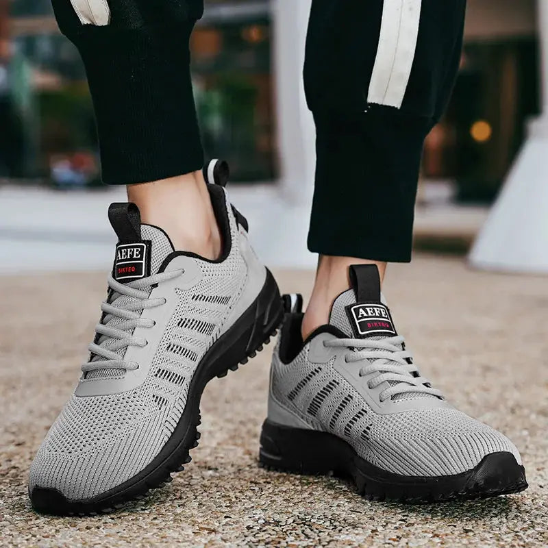 Men's grey mesh running shoes pair with black sole by Simples Market