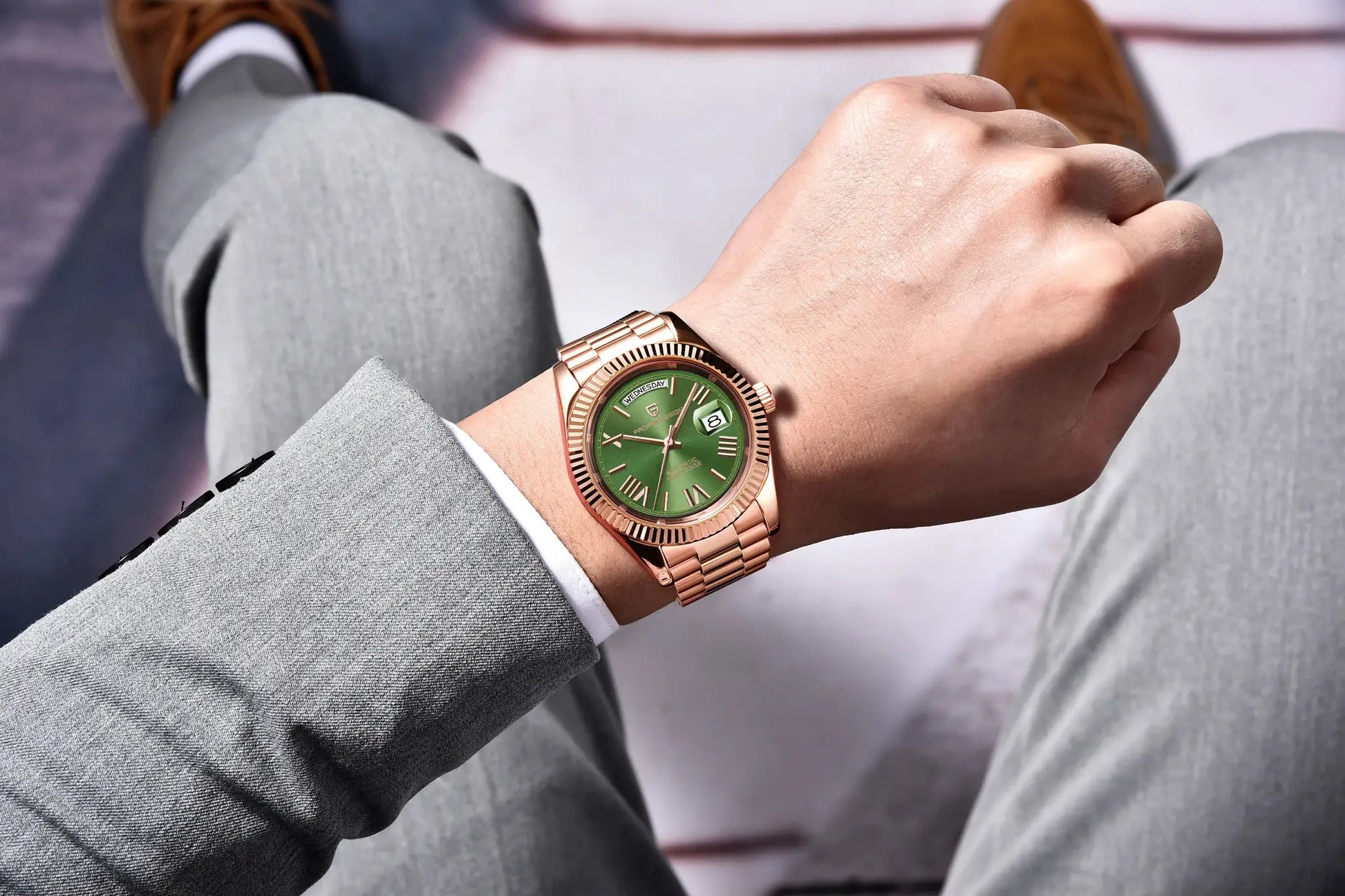 PAGANI DESIGN DD40 rose gold stainless steel wristwatch with green dial on a grey-suited man’s wrist