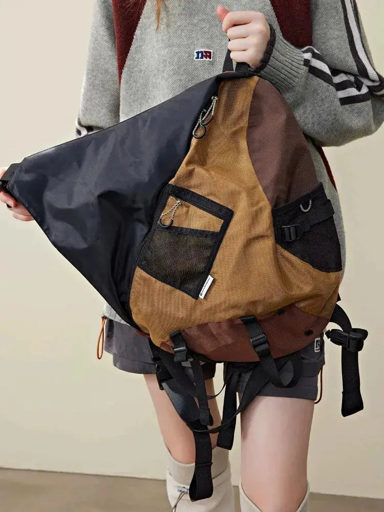 Y2k nylon crossbody bag in black and brown panels with mesh front pocket, multiple straps, and D-ring loops