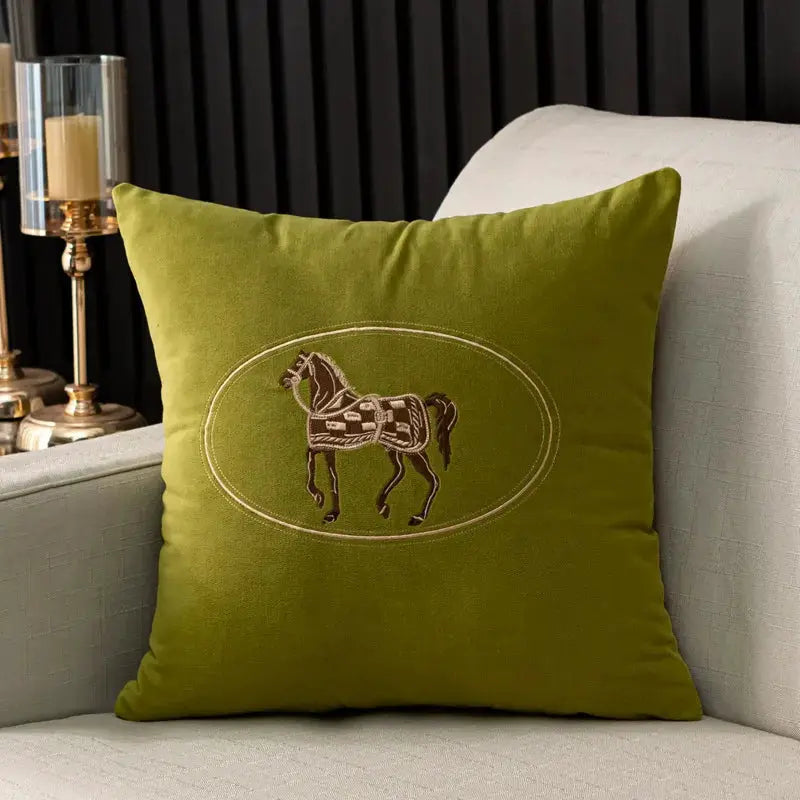 Cushion cover olive green with hand-embroidered horse design in an oval frame, 45x45 cm.