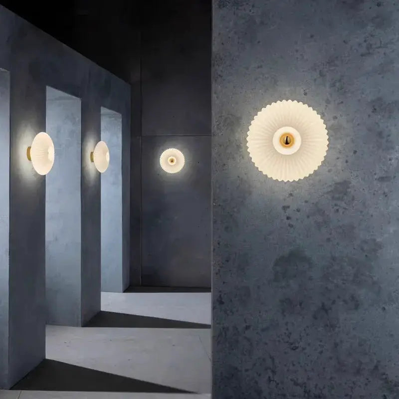 Nordic LED glass wall sconce, white ribbed shade with gold base; set of 4 on blue-gray walls