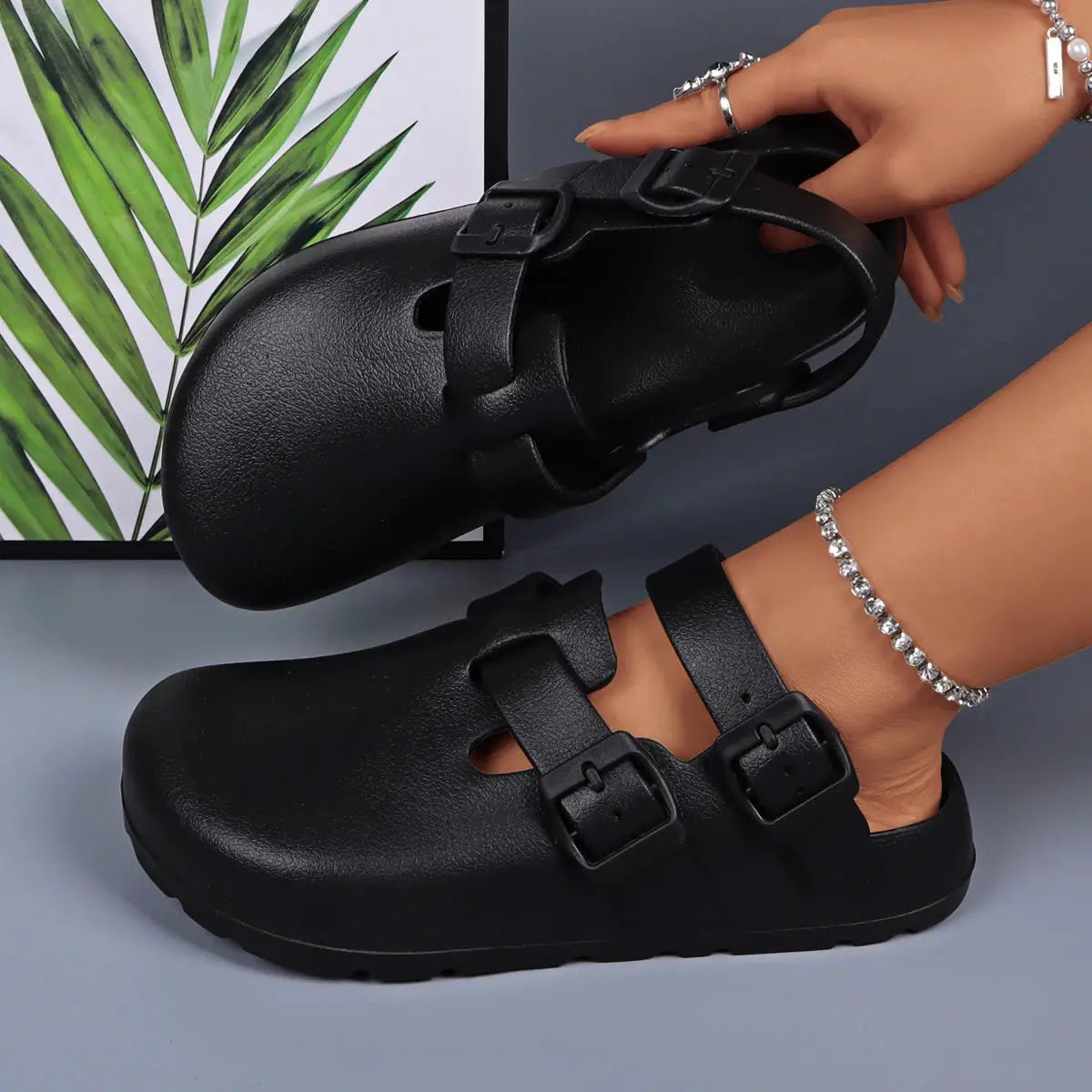 Pair of black platform sandals with two adjustable buckle straps