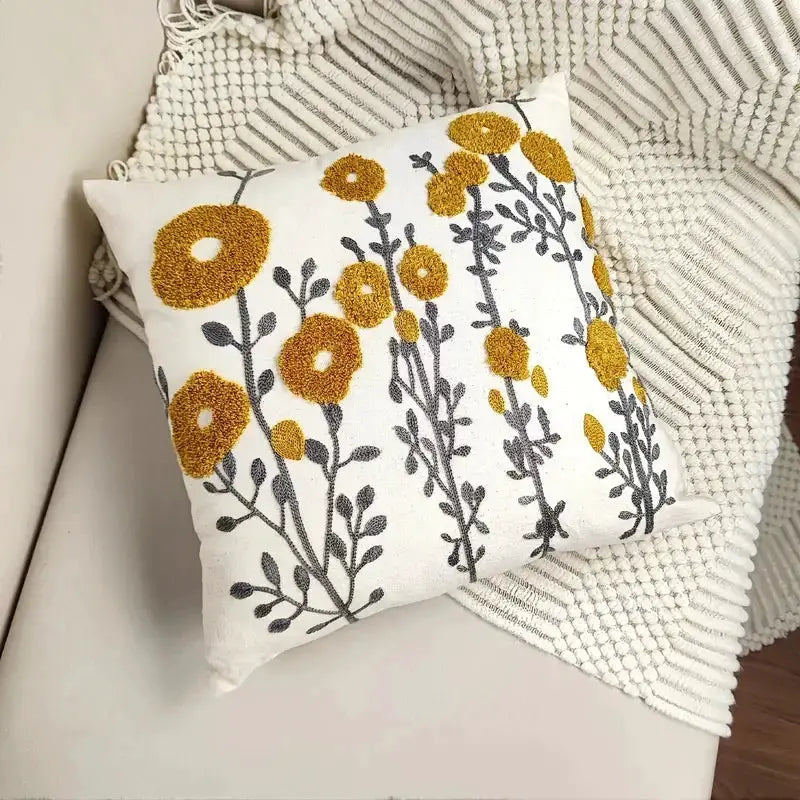 Cotton throw pillow cover with boho floral tufted embroidery; white with yellow flowers and gray stems