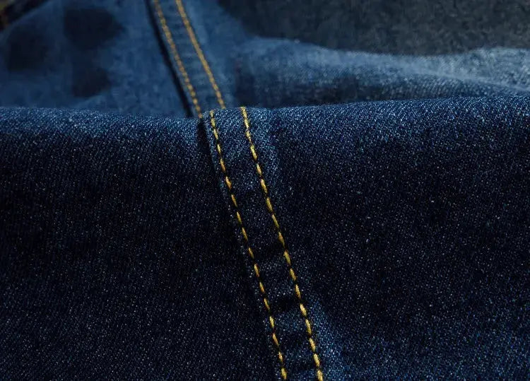 Blue denim jeans vest close-up with yellow stitching, sleeveless menswear