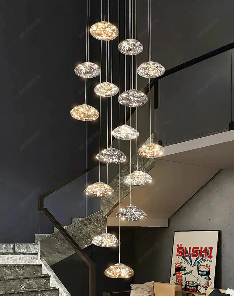 Pendant lights by Simples Market: 15 glass disk LED chandeliers hanging at varying heights in a modern dining room.