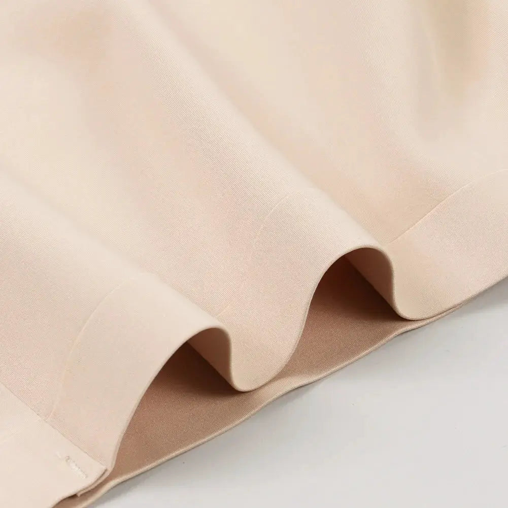 Sexy seamless strapless tube top bra in nude beige fabric close-up