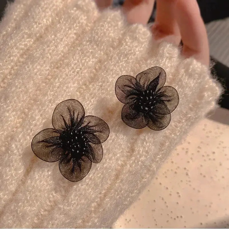 Enamel flower earrings, pair in black with sheer petal design