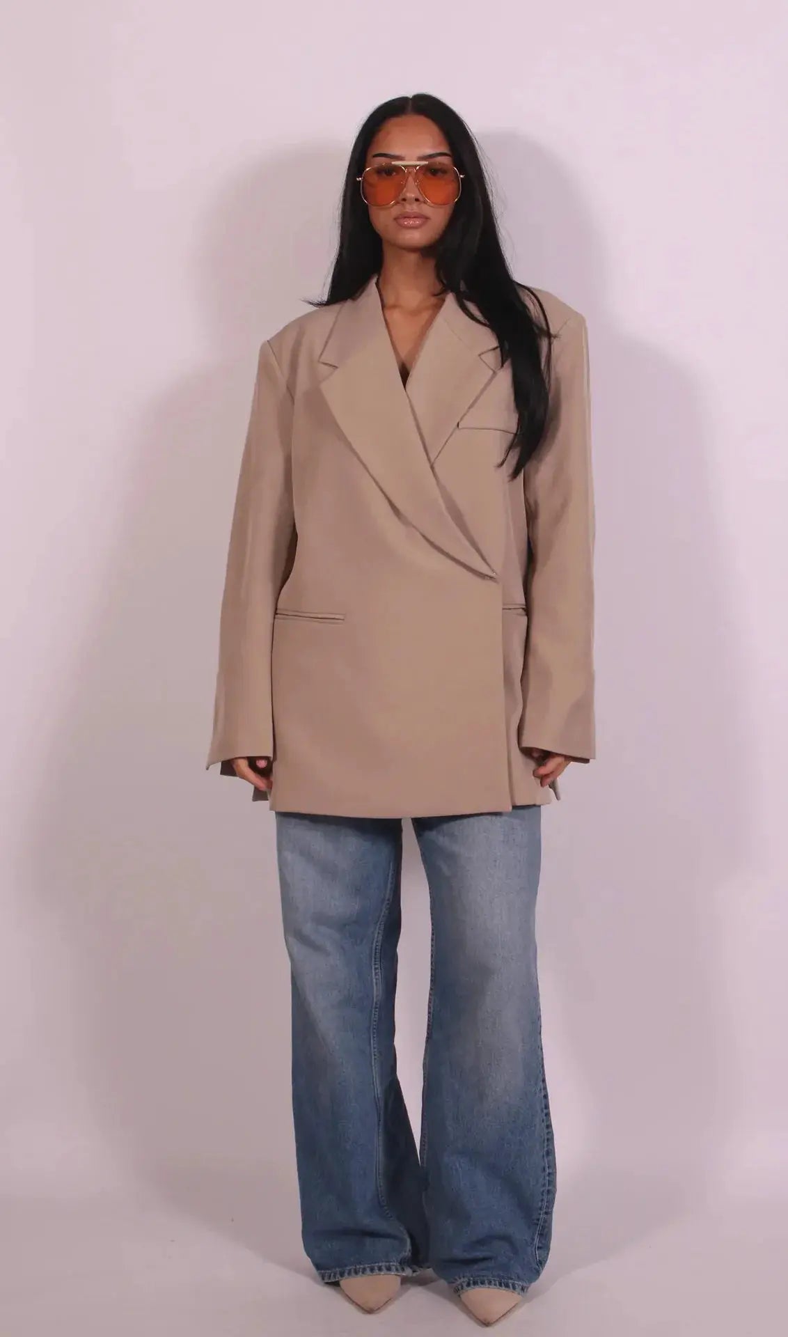 Beige oversized blazer coat by Simples Market with wide lapels, worn with blue jeans