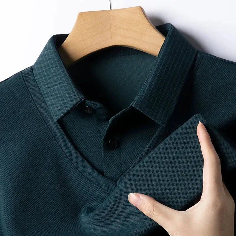 Men's long-sleeve polo shirt in dark teal solid color pique knit fabric on hanger