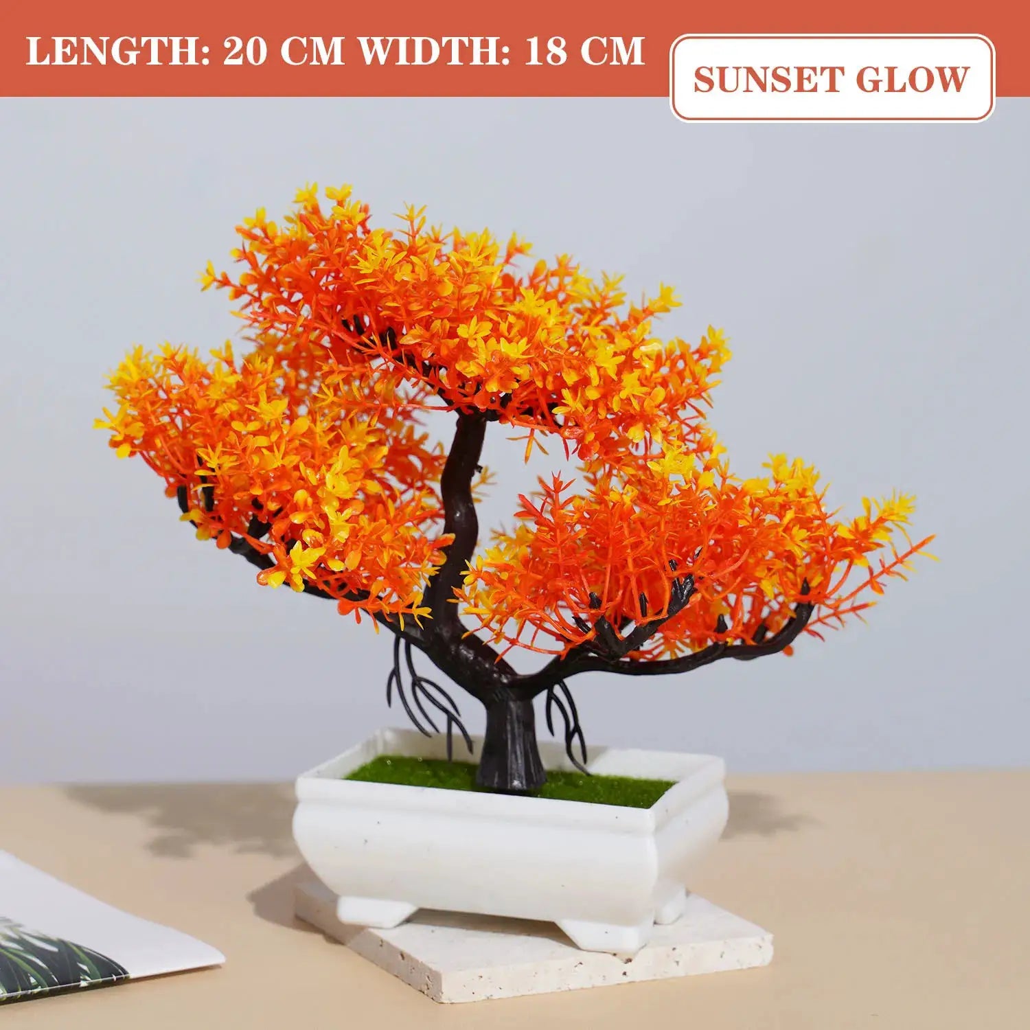 Artificial bonsai tree with bright orange leaves in a white ceramic pot for tabletop decor