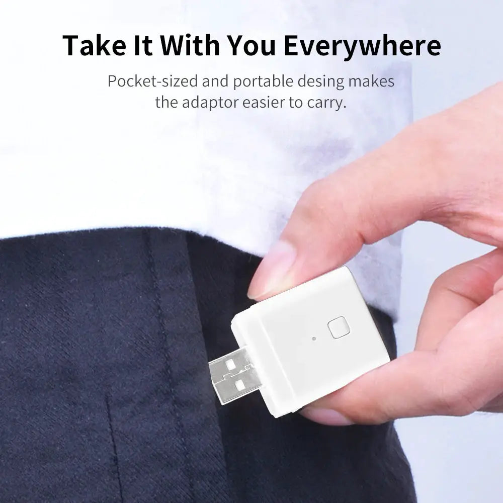WiFi USB adaptor, white pocket-sized 5V USB power plug held for on-the-go use.