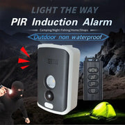 Wireless PIR infrared thermal outdoor alarm by Simples Market; gray sensor unit and black remote.