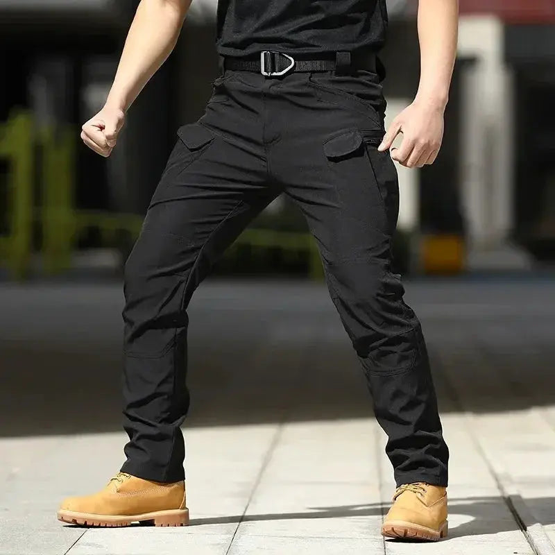 Men's black waterproof tactical cargo pants with multiple pockets and belt