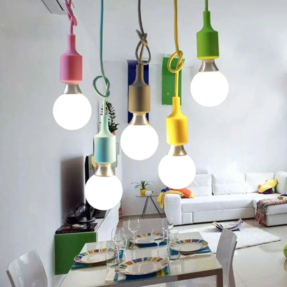Pendant lights, six colorful silicone-sleeved pendants with round bulbs over a modern dining room.