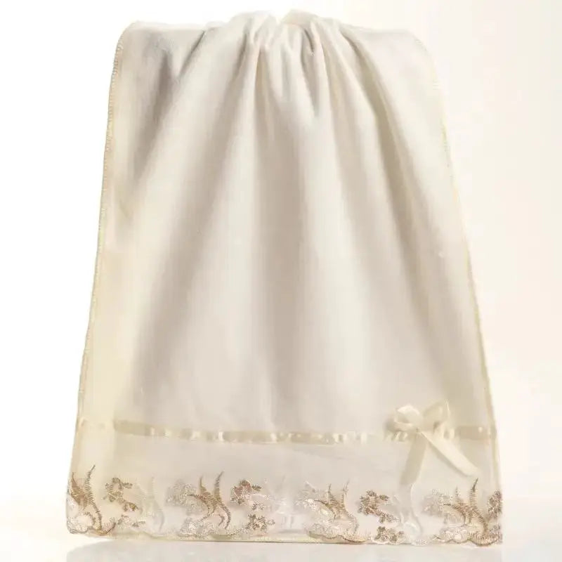 Simples Market lace-embroidered microfiber bath towel, white with delicate bottom lace trim and bow.