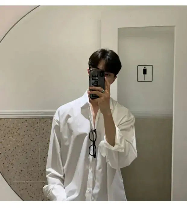 White solid-color men's long-sleeve shirt worn by model in a mirror selfie