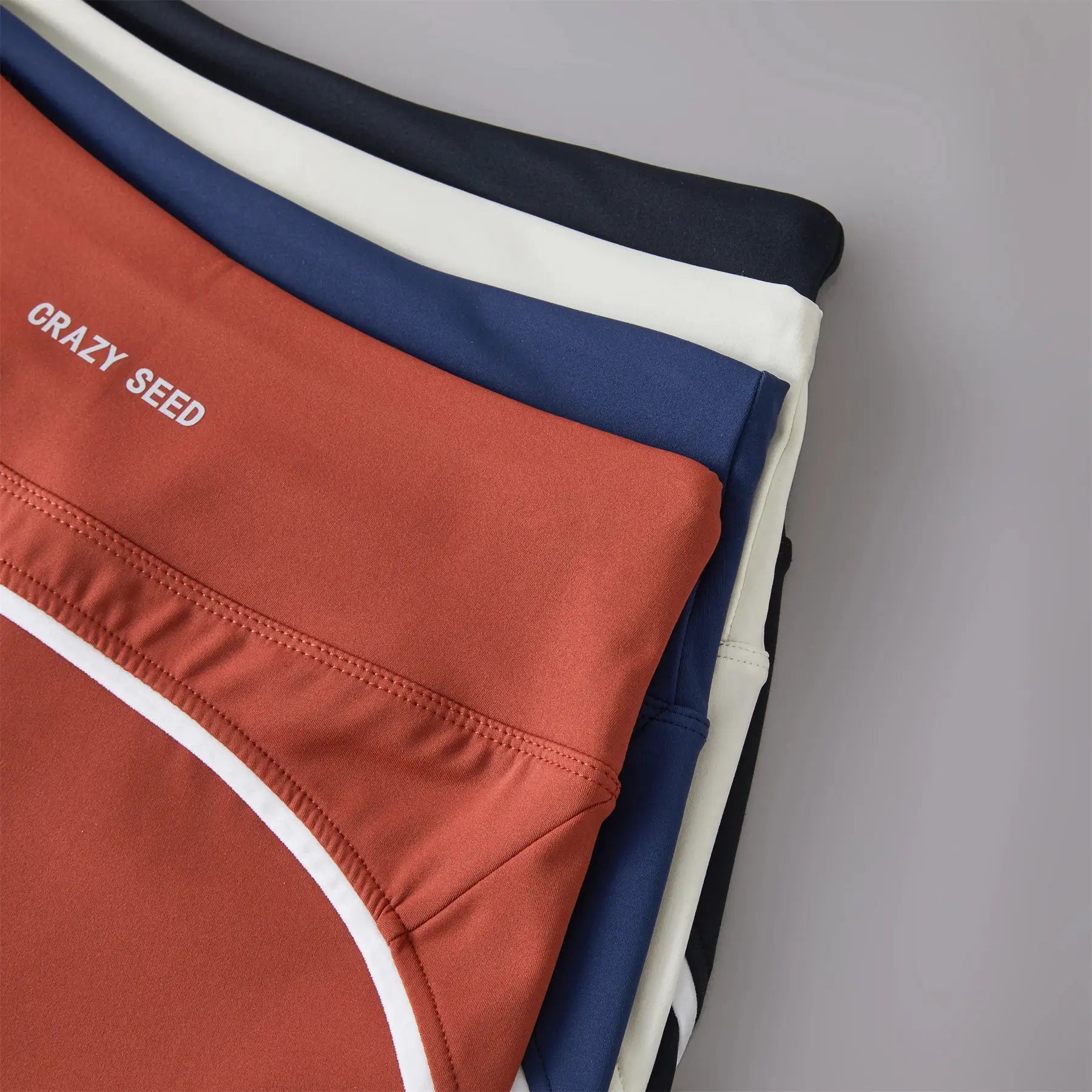 High-waist sports shorts stack in peach, white, navy, and black — five colors, Simples Market.