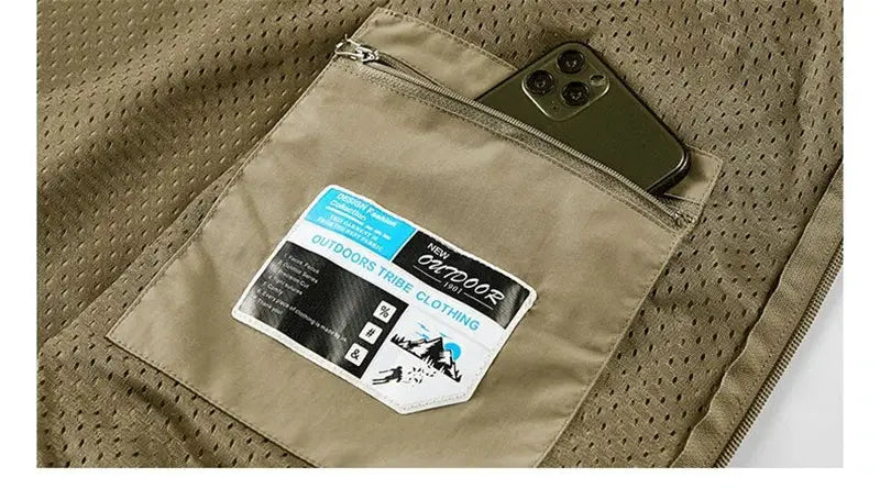 Simples Market men's sleeveless vest with multiple pockets in tan fabric, phone tucked in outer zip pocket