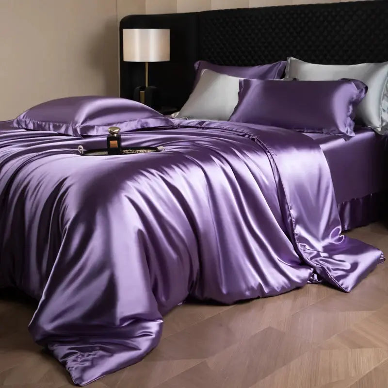 Silk bed sheet set in purple with duvet cover, fitted and flat sheets, and pillowcases