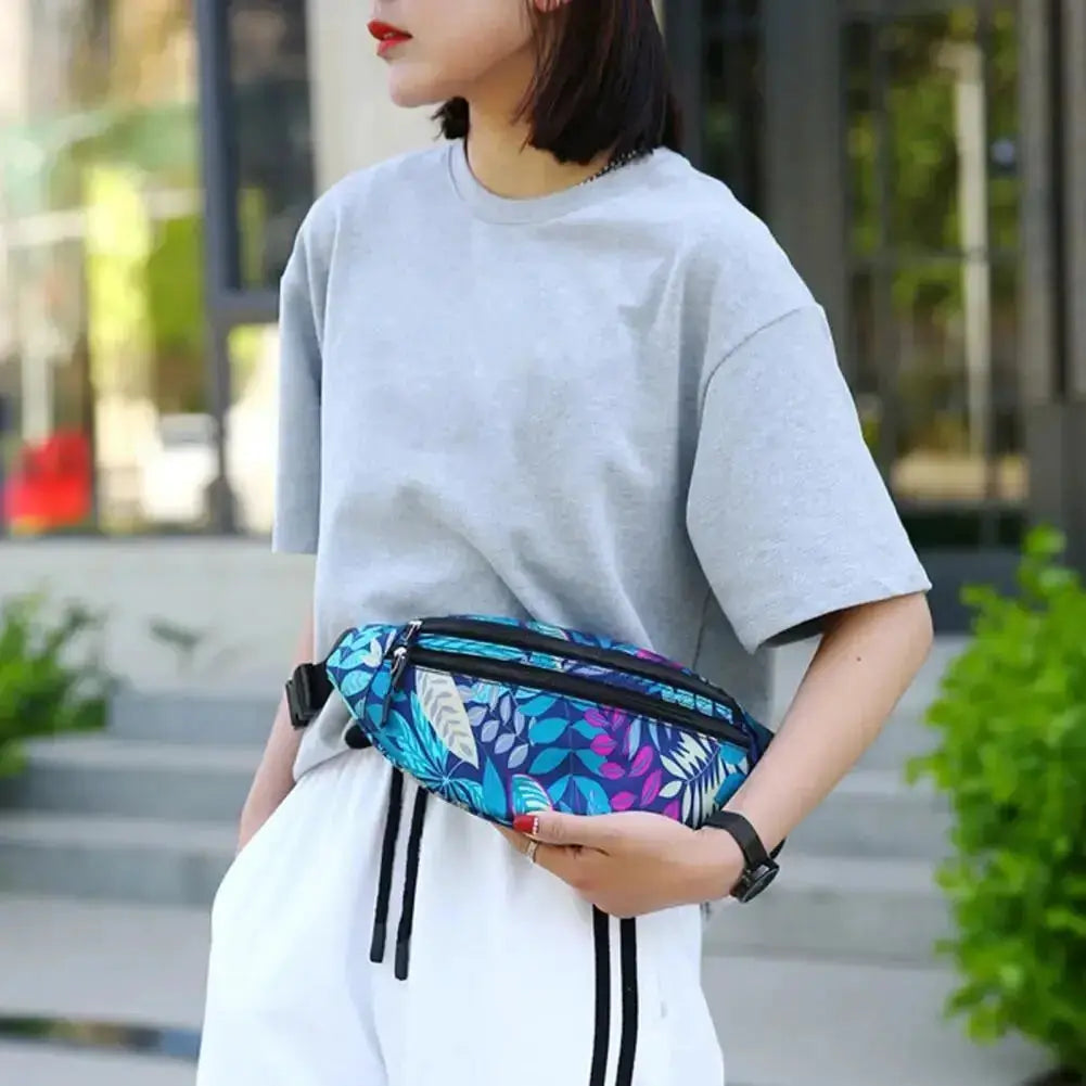 Sports waist pack with blue floral pattern worn at the waist; waterproof fanny pack for phone and essentials.
