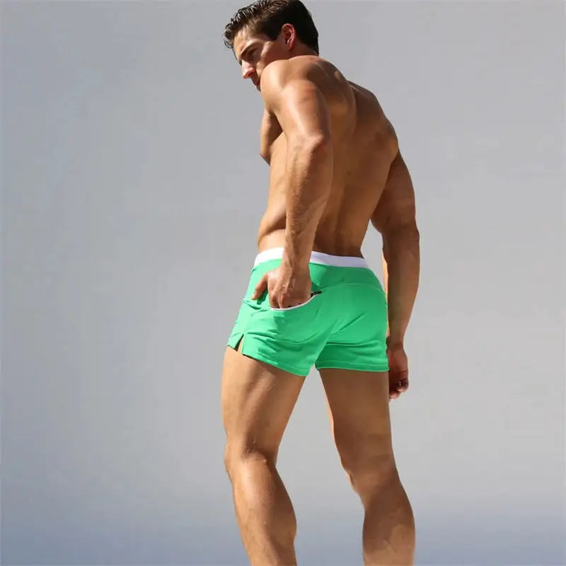 Men's green quick-drying swim trunks with back pocket design