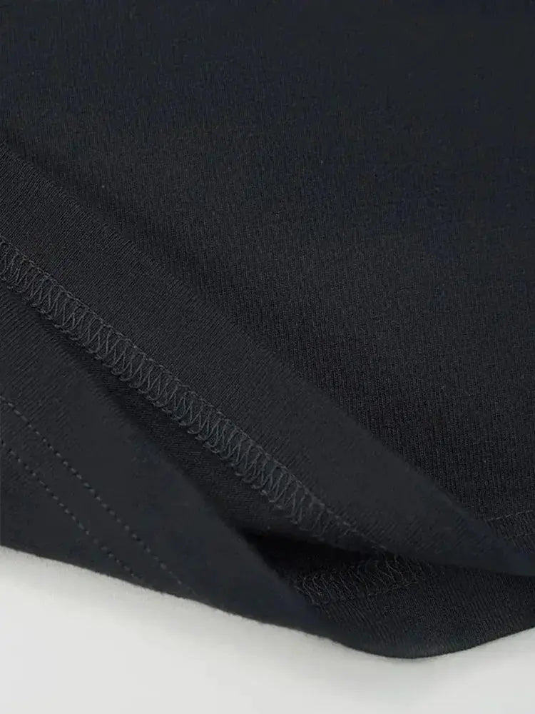 Cycling sweatpants in black fabric close-up with reinforced seam detailing