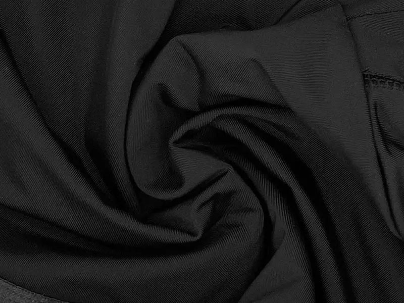 Men's black body shaper compression shorts; close-up of stretchy fabric.
